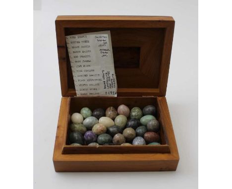 A thuja burr aromatic wood box containing ovoid stone samples to include; rose quartz,&nbsp;jade stone, etc.