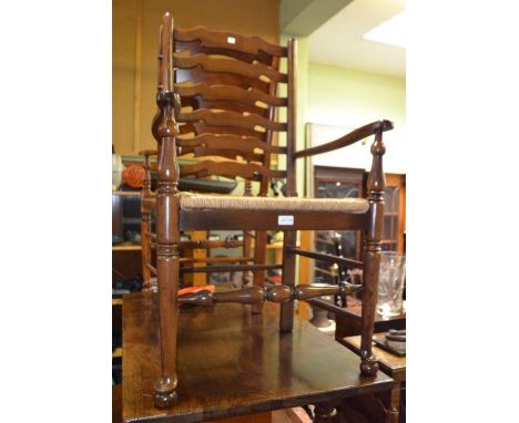 Five ladder back chairs with rush seats, three singles and two carvers