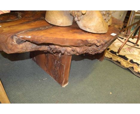 A wooden coffee table made from a single slice of trunk