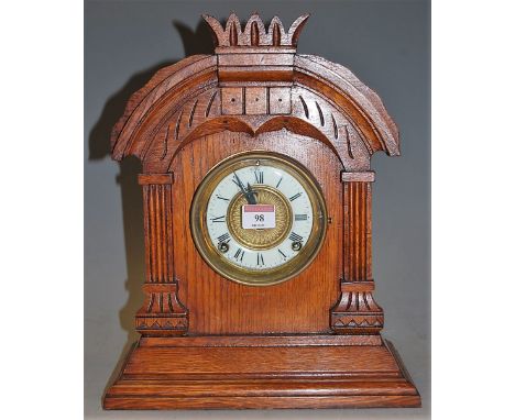 A late 19th century oak cased mantel clock having an enamelled chapter ring with Roman numerals and 8-day movement by the Ans