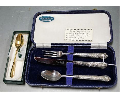 A mid 20th century cased knife, fork and spoon set, each having silver handles, together with a modern silver gilt teaspoon