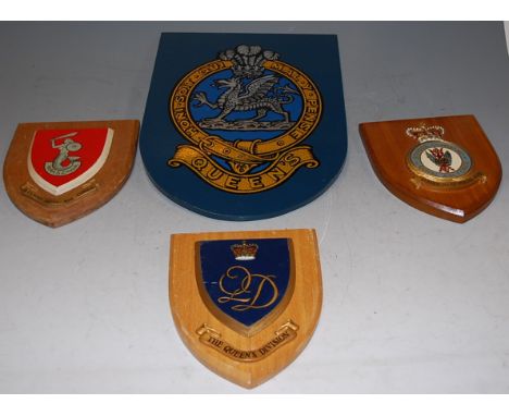 A collection of assorted military shield shaped wall plaques, to include Royal Air Force Flying School, The Queens Division, 