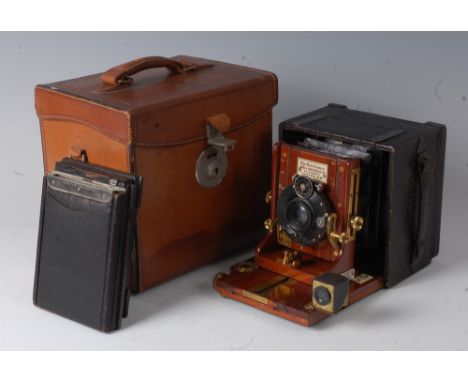 A James A Sinclair 'The Una' hand camera, 3¼ x 2¼", with DRP compound lens, brass fittings, leather bellows, all housed in or