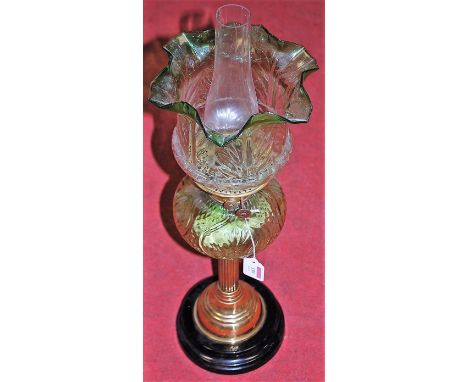 A Victorian oil lamp, having a green tinted glass shade above a further green tinted glass font, on brass pedestal base, h.58