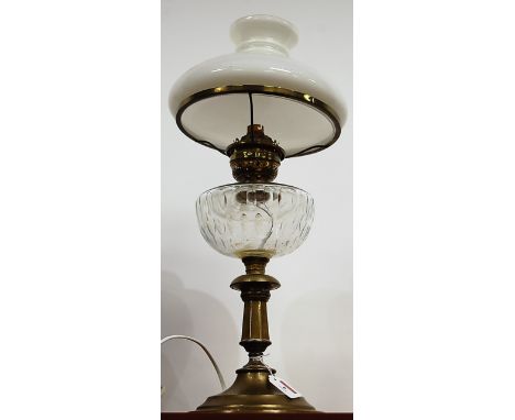 An early 20th century oil lamp, having opalescent glass shade and clear glass font on pedestal base (converted for electricit