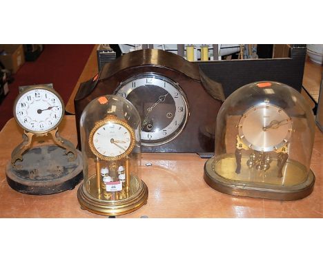 A 1950s bakelite cased mantel clock having a silvered chapter ring with Arabic numerals together with a lacquered brass anniv