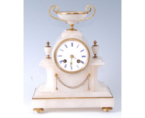 A late Victorian alabaster and gilt metal mantel clock under glass dome, the clock surmounted with a pedestal bowl over white