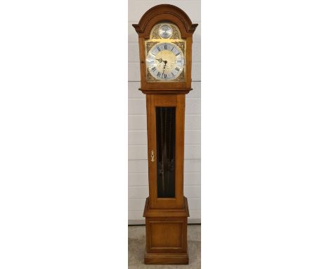 A mid century light wood cased Tempus Fugit grandmother clock. Brushed brass face with decorative pierced work brass overlay 