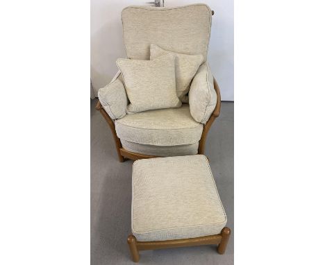 A modern Ercol light elm framed armchair and matching footstool, with cream coloured cushions. With slatted back and sides. I