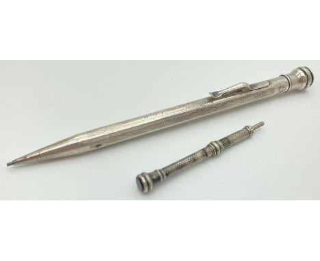 A silver filled propelling pencil by Eversharp with engine turned decoration and initials "W.J.C " to square cartouche. Toget