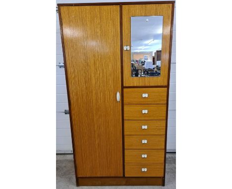 A mid century solid wood gentleman's wardrobe in light &amp; medium wood finish. With period metal handles, mirrored cupboard