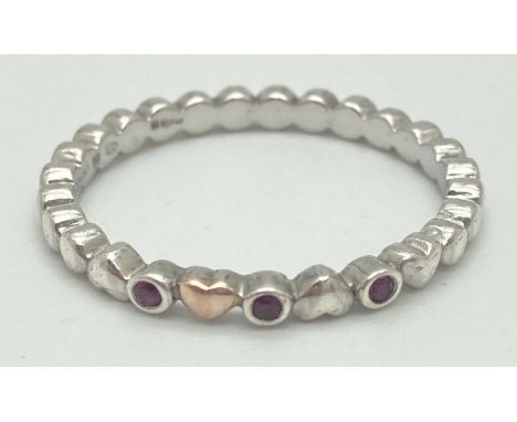 A 925 silver and ruby Clogau stacking ring with welsh gold accent &amp; heart detail. Silver and makers marks to inside of ba