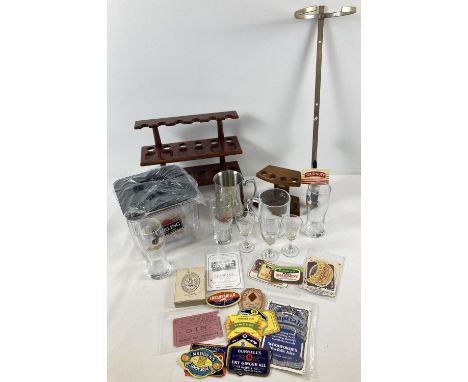 A box of assorted breweriana and pub related items. To include a collection of bottle labels, advertising ice box, pipe racks