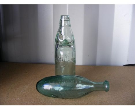 Two vintage Bottles: a marble bottle for F T Phillips of March, and a bullet Soda Water bottle for I H Thomas of Boston.