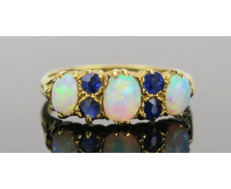 White Opal and Sapphire Ring in an 18ct hallmarked gold setting, 17mm head, size K.75, Birmingham 1938, maker R.P, 3.5g 