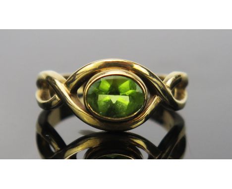 Peridot Dress Ring in an unmarked gold setting, size O.5, 4.8g 