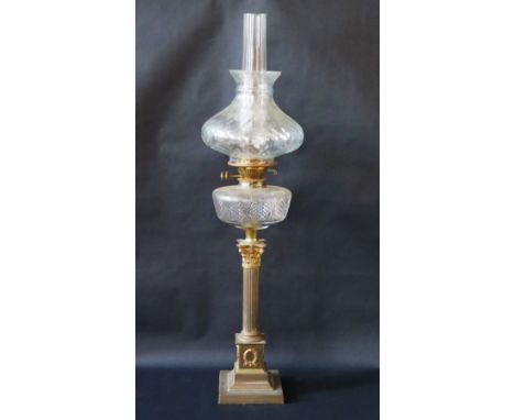 An Edwardian brass and glass oil lamp, the Corinthian column on plinth step base, chimney, shade and cut glass reservoir, 87c