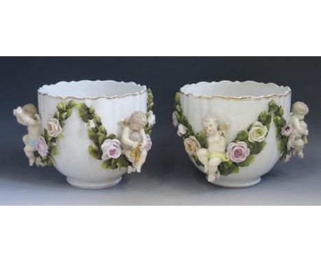 A pair of late 19th Century Sitzendorf cache pots, decorated with swags of roses and cherubs, 18x20cm, (2). 