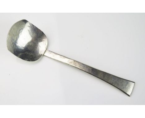 A hammered silver preserve spoon, unmarked except for makers mark E.H.J, with square-shaped bowl and tapering stem, 13.5cm lo