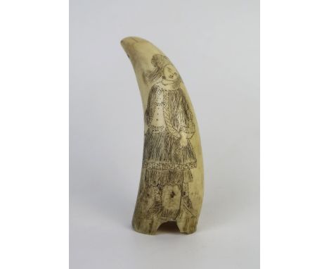 19th Century Scrimshaw Whale's Tooth, decorated with a lady, prick and lamp black, c. 11cm long 