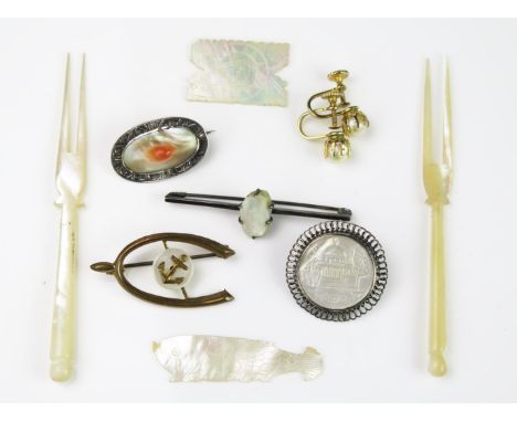 A Group of Mother of Pearl, to include a pair of pickle forks, two games counters, a bar brooch, a horse shoe and anchor broo
