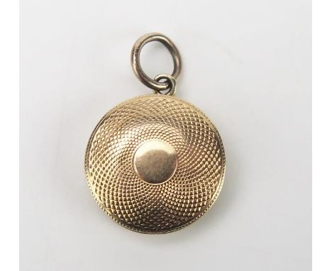 Antique Gold Pendant Mourning Locket, of circular form, with engine turned decoration, the hinge lid opens to reveal a twist 