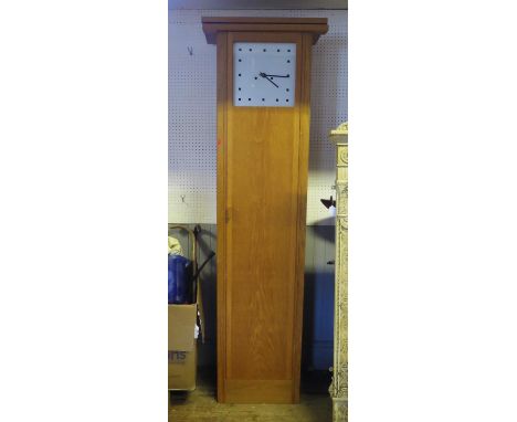 A Miles Carter designed modernist light oak longcase clock, of plain rectangular form having a 30cm dial with black squares f