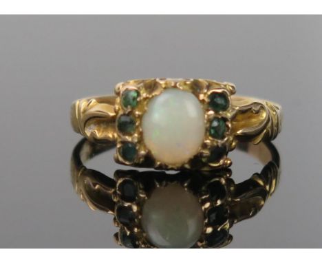 An Antique Opal, Greenstone and 15ct Gold Ring, the central oval stone red/green flashes, decoration worn, ring size I.5, 1.6