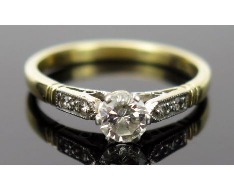 Diamond Solitaire Ring in a platinum setting with two chip diamonds to each shoulder, EDW .5ct, size M, 2.6g 