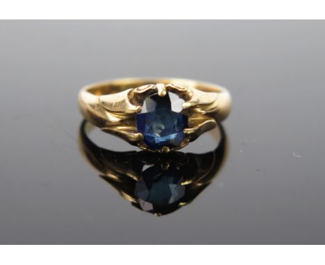 A Gold and Sapphire solitaire ring, dark stone 5mm, unmarked gold, ring size approximately R. 