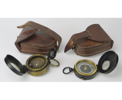 Two army style compasses contained in stitched leather cases. 