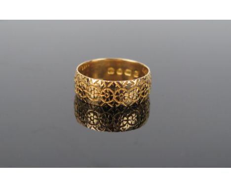 An 18ct Gold wedding ring, with engraved decoration, London 1913 or 38, 6.5mm wide, size L.75, 4.5g