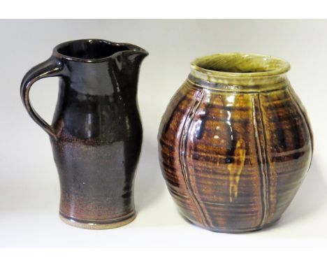 A Keith Smith (born 1946),Studio Pottery, brown glazed jug, 20cm high, together with a  ribbed jar/vase, 19cm high, both impr