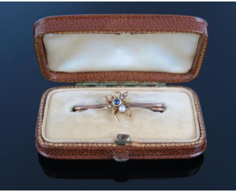 An Edwardian gold, untested pearl and sapphire bar brooch, not marked, 27mm, 1.8g, in a fitted brown leather case.