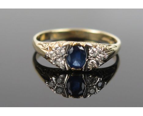 A Sapphire, Diamond and 9ct Gold Ring, the central oval stone c. 5x4mm, size P, 3.2g