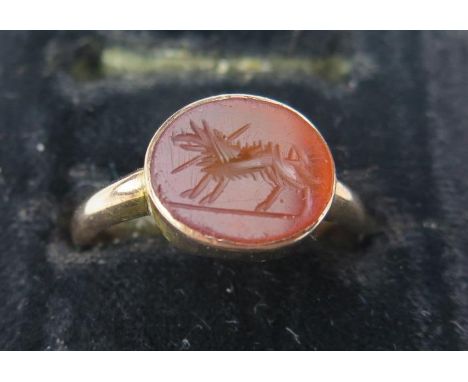 An Antique Rose Gold and Engraved Carnelian Seal Ring, in the Roman Style, not marked, the oval stone 10x9mm, ring size M.25,