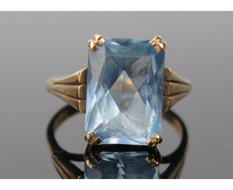 A 9ct Gold and pale blue stone Cocktail Ring, baguette cut 13x11mm, stamped 9ct.