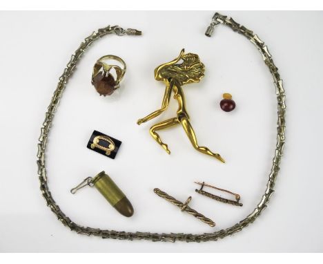 A Group of Costume Jewellery, to include a brass articulated pendant of a woman, an unmarked white metal necklace, a gold pla