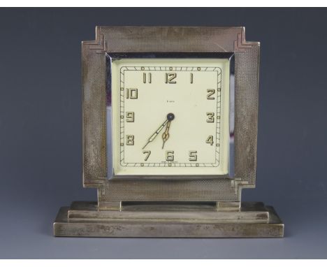 A George V silver cased mantel timepiece, maker's mark worn, Birmingham, 1935, of square outline with 6.5cm Arabic dial, on a