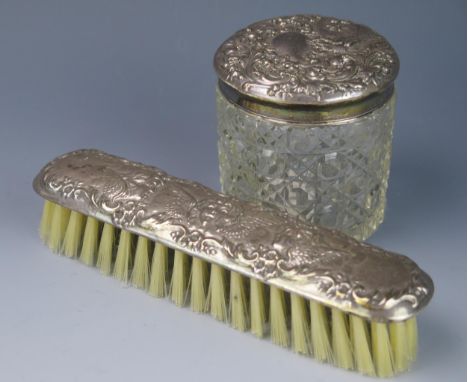 A late Victorian clear glass and silver mounted dressing table jar and a silver backed brush (2). 