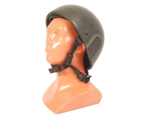 A British military army uniform combat helmet ' MK 6 '. Circa 1987, having a khaki green shell, padded interior with webbing 