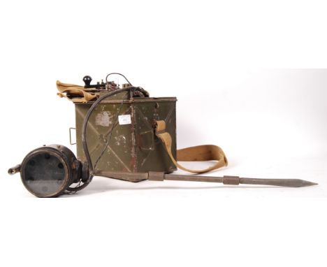 A WWII Second World War daylight short range Heliograph signal lamp:, in a green metal case with lamp and screw-in multi sect