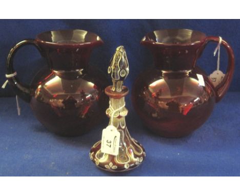 Pair of ruby glass, baluster shaped jugs with loop handles, together with a Victorian double overlay, glass scent bottle and 