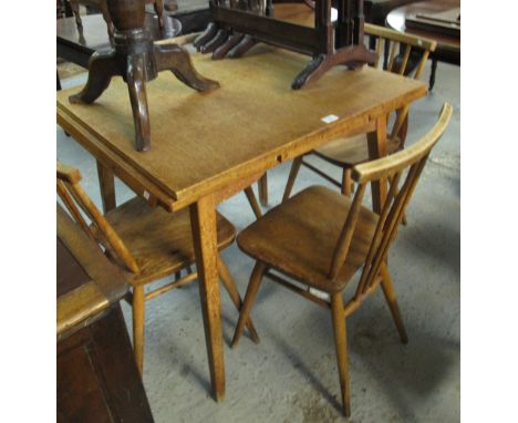 20th Century elm Ercol extending dining table together with four matching spindle back Ercol chairs. (5)