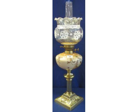Early 20th Century brass double burner oil lamp, having ceramic reservoir, repousse brass pedestal, lustre shade and clear ch