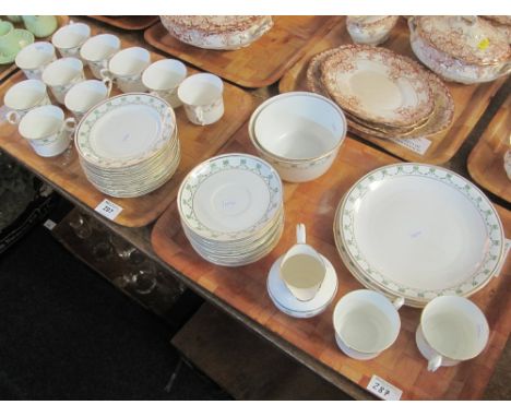 Two trays of 19th Century teaware on a white ground with ribbon and swag decoration comprising: cups; saucers; plates; sugar 