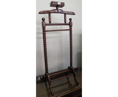 Reproduction stained valet on bobbin turned supports.