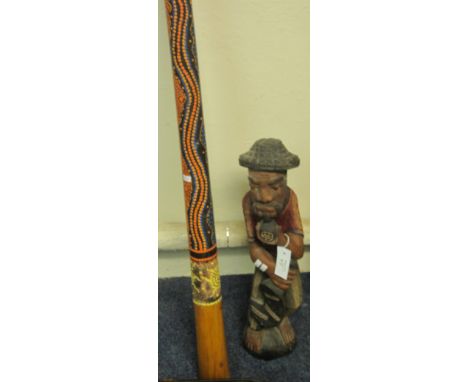 Australian traditionally decorated didgeridoo, together with an African carved wooden figure. (2)