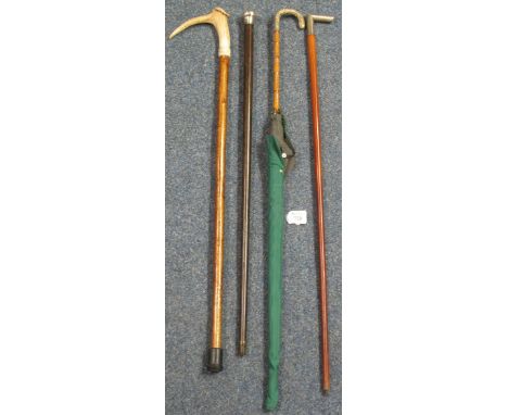 Cane parasol with white metal mount, a hardwood walking cane with silver knop, another walking cane with white metal handle a