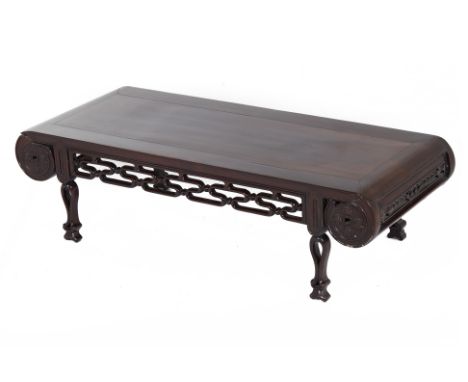 A CHINESE HARDWOOD KANG OR COFFEE TABLE Carved with a pierced lattice apron to each side, scroll ends with coin decoration 30